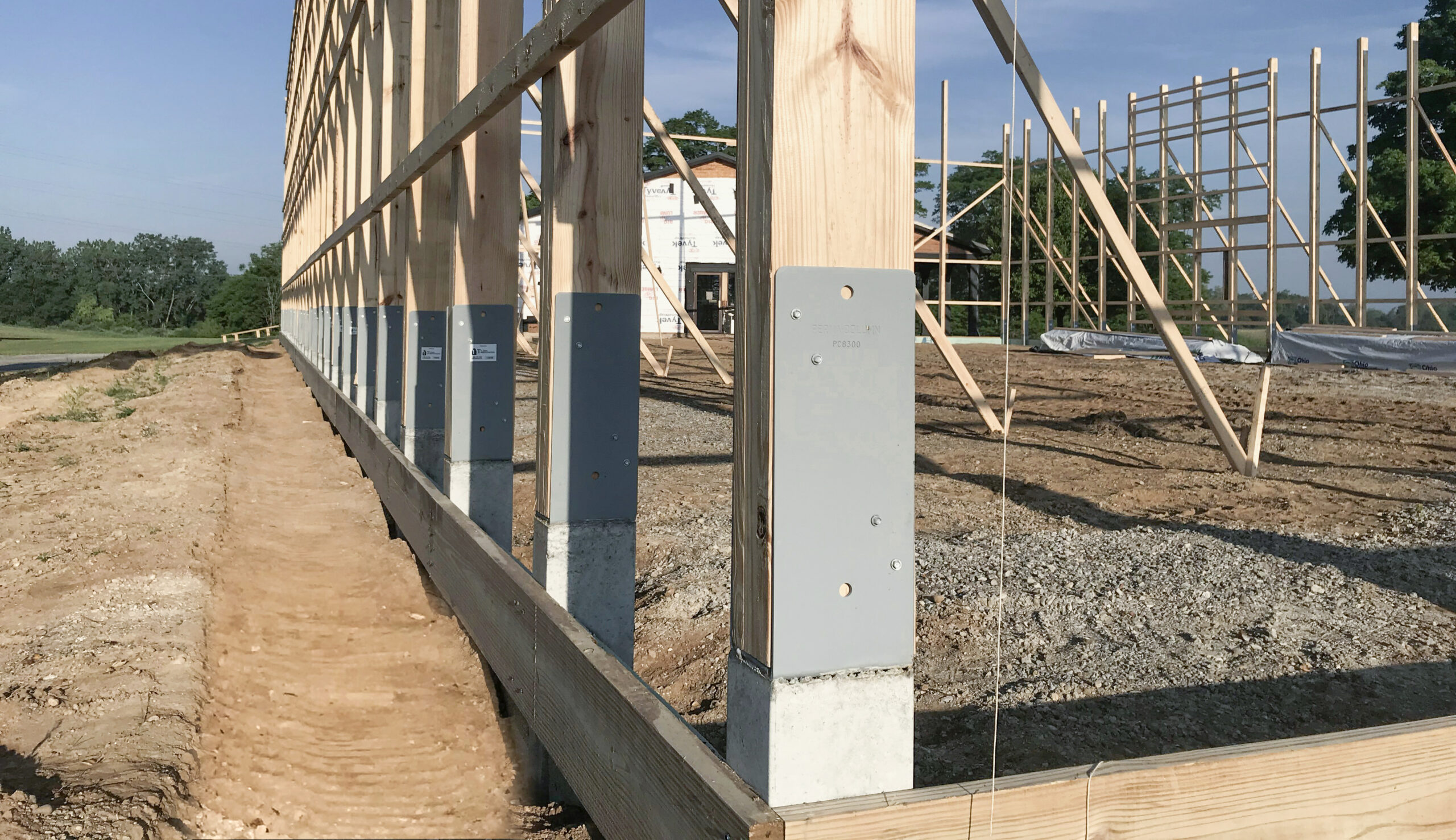 Prema-columns are preceast concrete columns for horse barns shown inside a horse barn installed